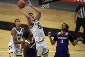 Iowa Center Luka Garza goes in for a basket during the Iowa v. Western Illinois basketball game in Carver-Hawkeye Arena on Thursday, Dec. 3, 2020. Iowa defeated Western Illinois with a final score of 99-58. Garza scored a total of 35 points.