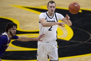 Iowa forward Jack Nunge throws the ball to a teammate during the Iowa v. Western Illinois basketball game in Carver-Hawkeye Arena on Thursday, Dec. 3, 2020. Iowa defeated Western Illinois with a final score of 99-58.