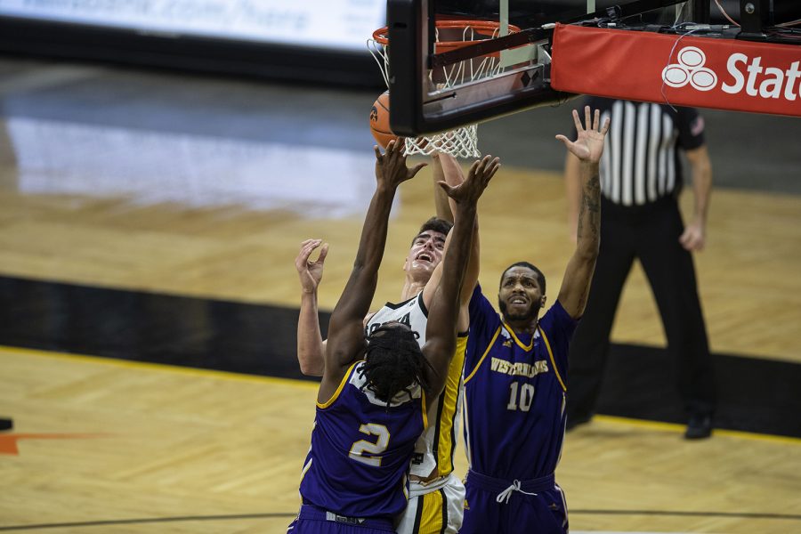 Iowa center Luka Garza goes in for a layup during the Iowa v. Western Illinois basketball game in Carver-Hawkeye Arena on Thursday, Dec. 3, 2020. Garza has scored 30 points so far for Iowa.