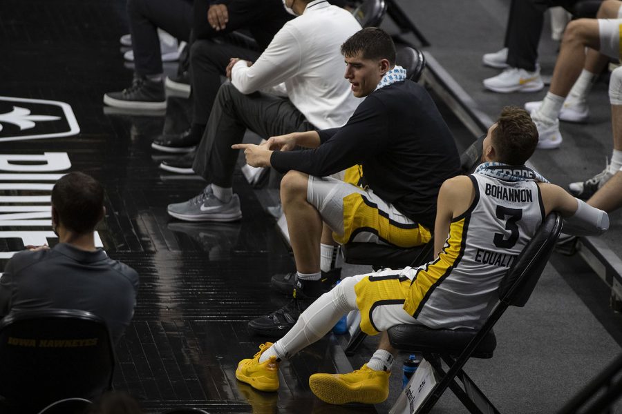 Iowa center Luka Garza and guard Jordan Bohannon talk on the sidelines during a basketball game against Northern Illinois on Sunday, Dec. 13, 2020 at Carver Hawkeye Arena. The Hawkeyes defeated the Huskies, 106-53. 