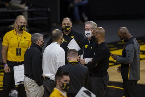 Iowa head coach Fran McCaffery speaks with the assistant coaches during a timeout for the basketball game against Northern Illinois on Sunday, Dec. 13, 2020 at Carver Hawkeye Arena. The Hawkeyes defeated the Huskies, 106-53.