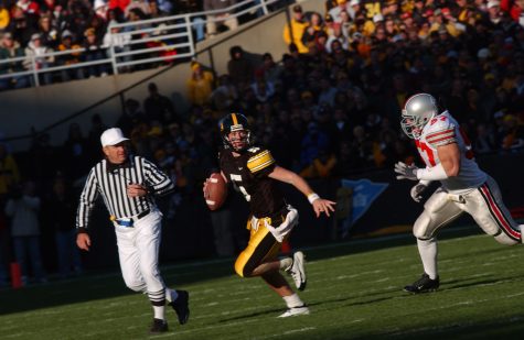 UI quarterback Drew Tate evades Ohio State defensive end Mike Kudla in the second half of the Hawkeyes victory over Ohio State on Oct. 16, 2004. Tate passed for 331 yards with three touchdowns, rushed for 24 yards with one touchdown and completed 26 of 39 passing attempts. 