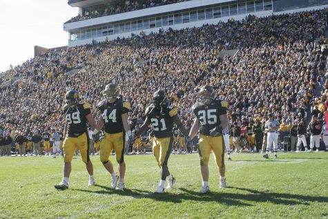 Iowa captains (from left) Bryan Mattison, Mike Humpal, Albert Young and Tom Busch take the field during the coin toss of overtime play against the Michigan State Spartans on Saturday, Oct. 27, 2007.