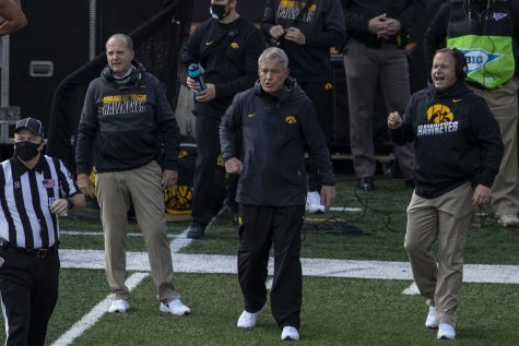 Head Coach Kirk Ferentz and Offensive Coordinator Brian Ferentz are seen without masks during the Iowa v Northwestern football game at Kinnick Stadium on Saturday, Oct. 31, 2020.  The Wildcats defeated the Hawkeyes 21-20. Many Iowa Coaches wore Gaitor face guards, which the CDC has suggested is not as effective against the spread of COVID-19 as a regular mask.