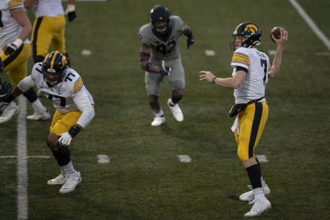 Saturday Dec. 5, 2020; Champaign, Illinois, USA; Iowa quarterback Spencer Petras (7) overthrows a pass towards the endzone during the second quarter of the Iowa v. Illinois football game at Memorial Stadium. 