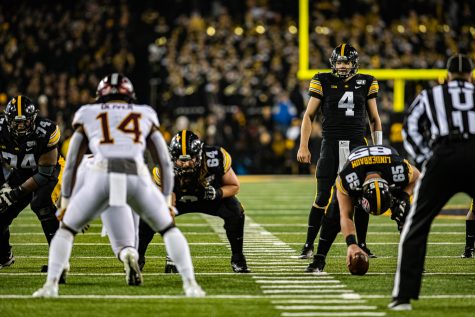 Iowa quarterback Nate Stanley surveys the defense during a football game between Iowa and Minnesota at Kinnick Stadium on Saturday, Nov. 16, 2019. Stanley was sacked twice in the Hawkeyes win.