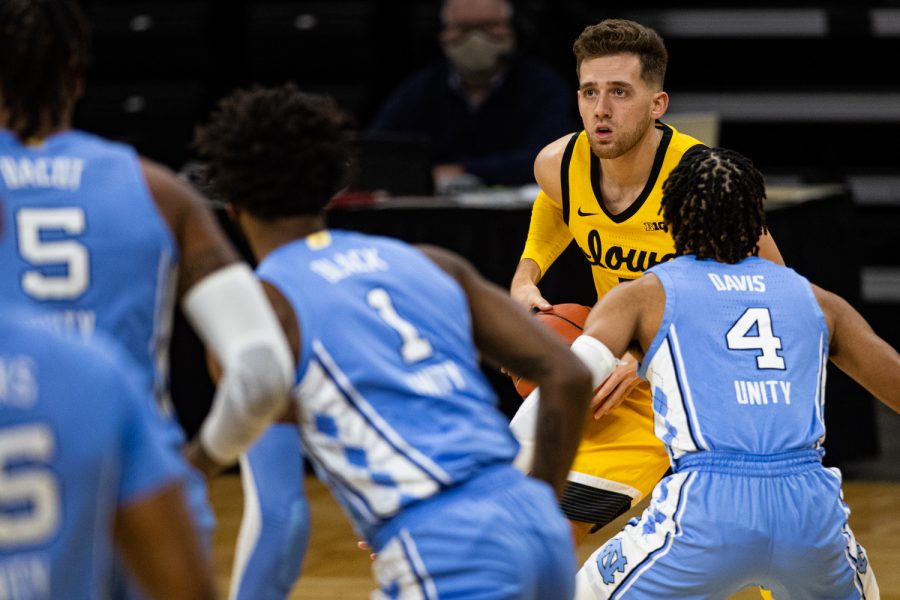 Iowa guard Jordan Bohannon looks to pass during a men’s basketball game between Iowa and North Carolina at Carver-Hawkeye Arena on Tuesday, Dec. 8, 2020. The Hawkeyes defeated the Tar Heels, 93-80. 