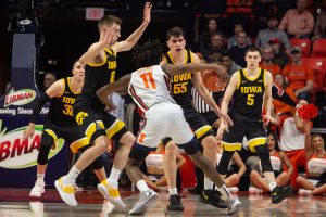 Iowa basketball players (left to right) Connor McCaffery, Joe Wieskamp, Luka Garza, and C.J. Fredrick block Illinois guard Ayo Dosunmu from shooting a basket during a game against the University of Illinois on Sunday, March 8, 2020, at the State Farm Center in Champaign, Ill. The Hawkeyes lost to the Fighting Illini, 76-78. (Emily Wangen/The Daily Iowan)
