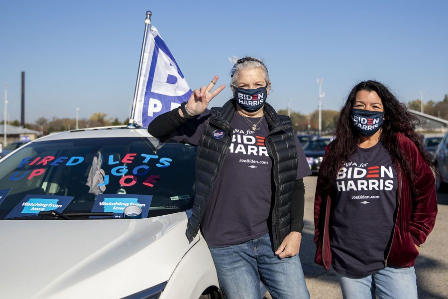 Volunteer with the Biden Flight Crew and Des Moines resident Charlie Jordan (left) and Missouri resident Corrinna Powers (right) pose for a portrait during a Biden drive-in rally on Friday, Oct. 30, 2020 at the Iowa State Fairgrounds in Des Moines. "We're going to have to have every single ballot, we'll need every single vote," said Jordan, who has been working at the phone banks and chasing ballots for the past few weeks. "It's a matter of getting those ballots in and making sure everyone understands if they made a mistake on their ballot, that they didn't waste their time and their ballot will be counted."