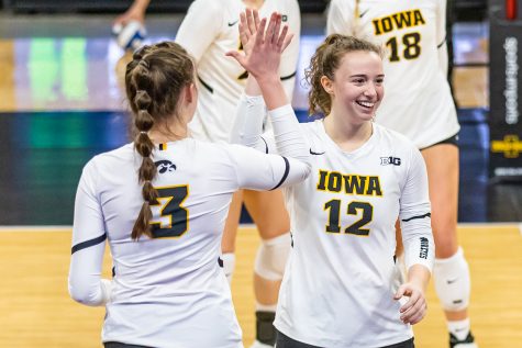 Iowa outside hitter Audrey Black and Iowa setter Bailey Ortega high five one another during the Iowa Volleyball season opener game against Illinois on Jan. 22, 2021 at Carver-Hawkeye Arena. Illinois defeated Iowa 3-1. 