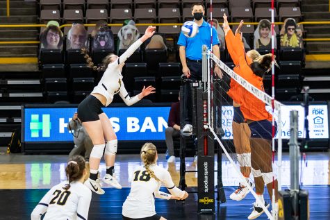 Iowa Outside Hitter Audrey Black hits the ball over the net during the Iowa Volleyball season opener game against Illinois on Jan. 22, 2021 at Carver-Hawkeye Arena. Illinois defeated Iowa 3-1. 