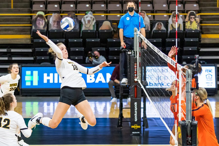 Iowa Middle Blocker Hannah Clayton hits the ball over the net during the Iowa Volleyball season opener game against Illinois on Jan. 22, 2021 at Carver-Hawkeye Arena. Illinois defeated Iowa 3-1. 
