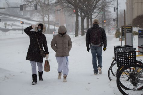Students are seen walking to and from class in the snow at the University of Iowa on Monday, Jan. 25, 2021.