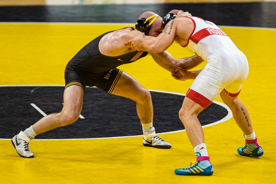 Iowa’s 165-pound Alex Marinelli grapples with Nebraska’s Peyton Robb during a wrestling dual meet between No. 1 Iowa and No. 6 Nebraska at Carver Hawkeye Arena on Friday, Jan. 15, 2021. No. 2 Marinelli defeated No. 18 Robb by decision, 9-3, and the Hawkeyes defeated the Cornhuskers, 31-6.