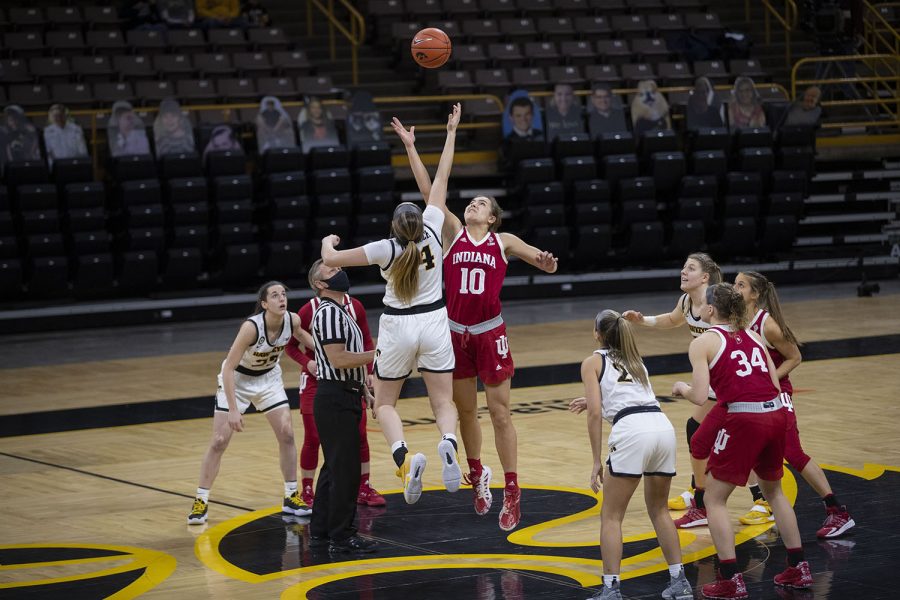 Iowa’s McKenna Warnock and an Indiana player tip off the ball to start off the game at the Iowa Women’s Basketball game against Indiana on Sunday, Feb. 7, 2021, at Carver Hawkeye Arena. Indiana defeated Iowa 85-72.