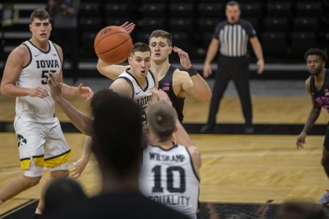Iowa guard CJ Fredrick passes the ball during a mens basketball game against Penn State on Sunday, Feb. 21, 2021 at Carver Hawkeye Arena. The Hawkeyes defeated the Nittany Lions, 74-68. (Hannah Kinson/The Daily Iowan)