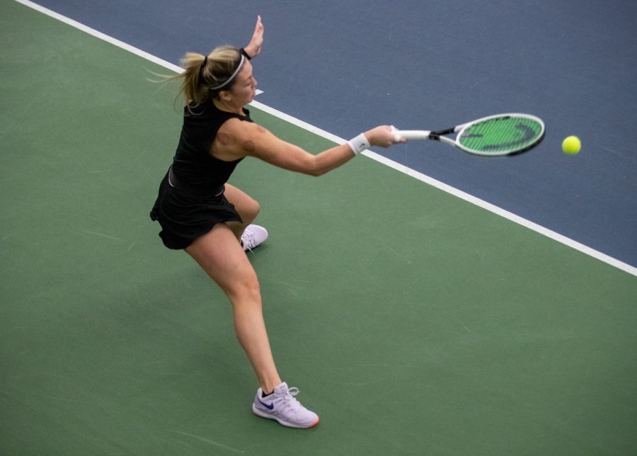 Iowa’s Alexa Noel goes low to return a ball during a womens tennis meet at the Hawkeye Tennis and Recreation Complex on Thursday, Feb. 26, 2021. The Hawkeyes defeated the Hoosiers with a score of 4-3.