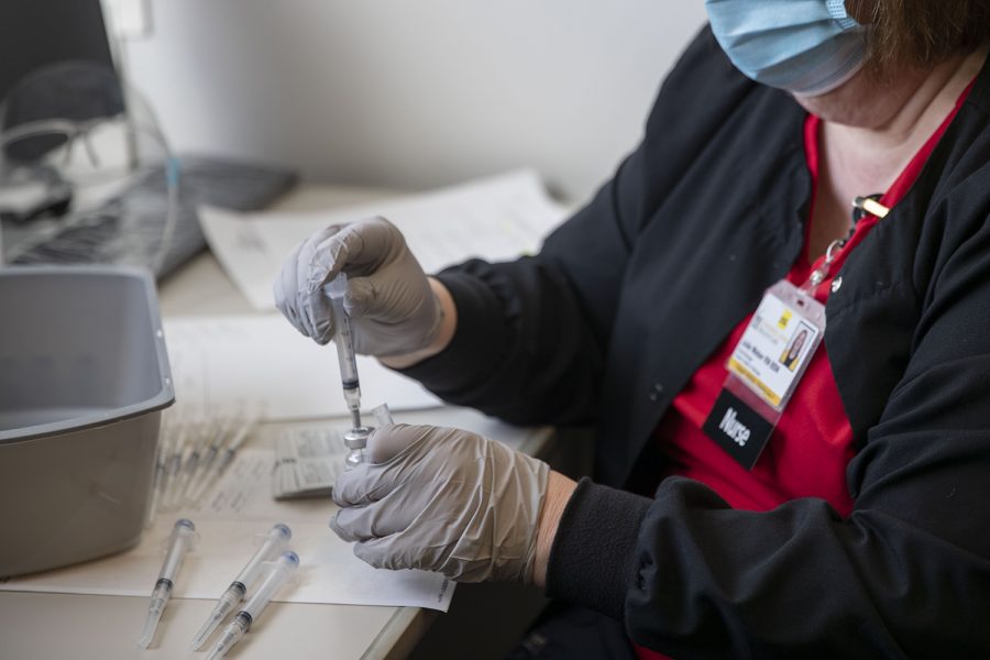 Student Health Nurse Manager, Julie Weber fills needles with the Moderna vaccine on Friday, Jan. 29, 2021 at the UI Medical Education Research Facility. (Hannah Kinson/The Daily Iowan)