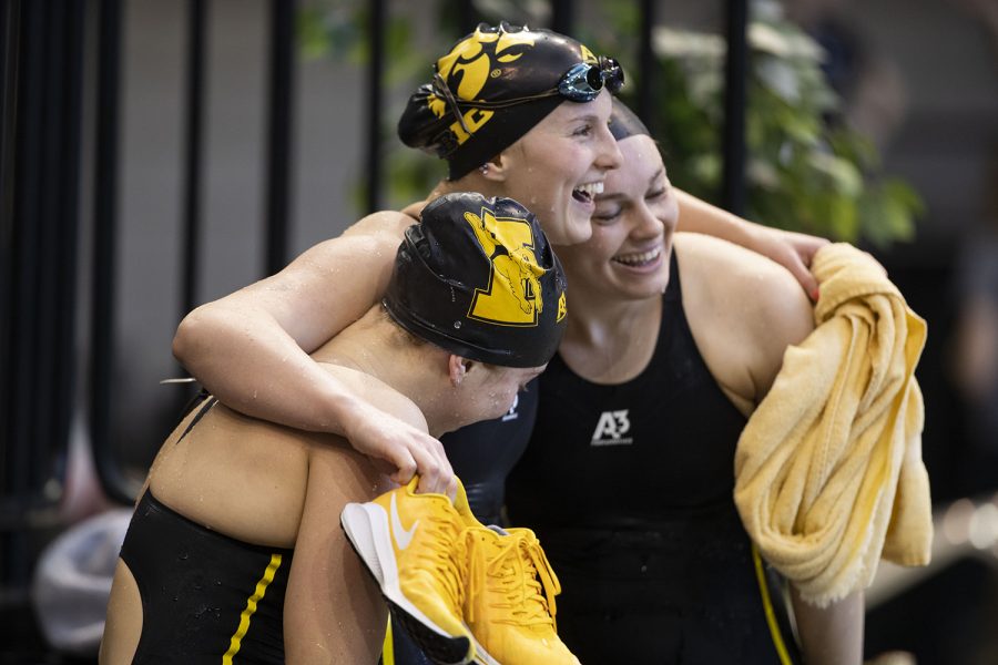 Iowa’s Christina Crane, Zoe Mekus, and Lexi Horner hug after competing in the 100 yard breaststroke time trial during the sixth session of the 2020 Big Ten Women’s Swimming and Diving Championships at the Campus Recreation and Wellness Center on Saturday, Feb. 22, 2020.