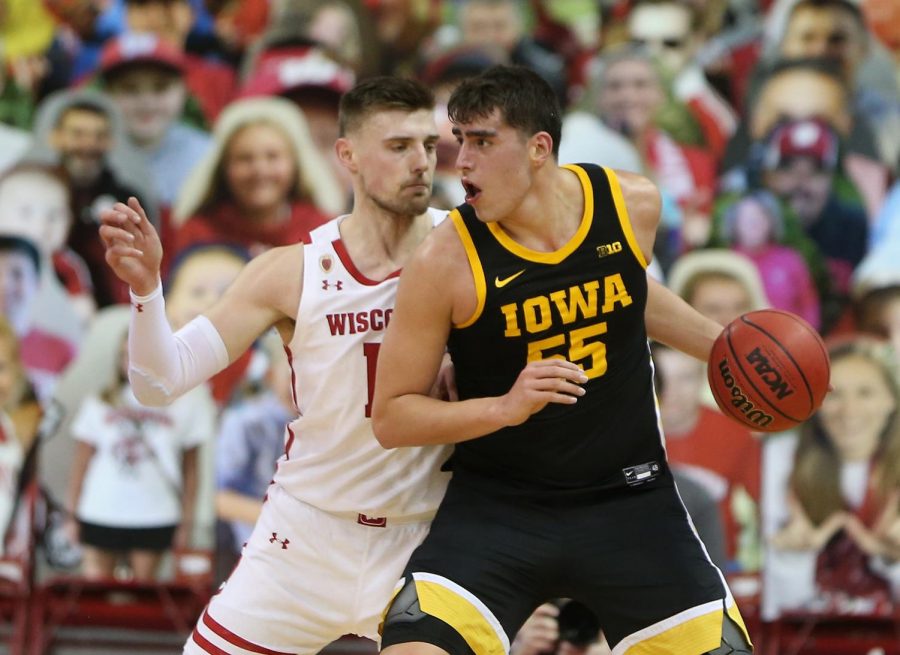 Feb 18, 2021; Madison, Wisconsin, USA; Iowa Hawkeyes center Luka Garza (55) works the ball against Wisconsin Badgers forward Micah Potter (11) during the first half at the Kohl Center. Mandatory Credit: Mary Langenfeld-USA TODAY Sports