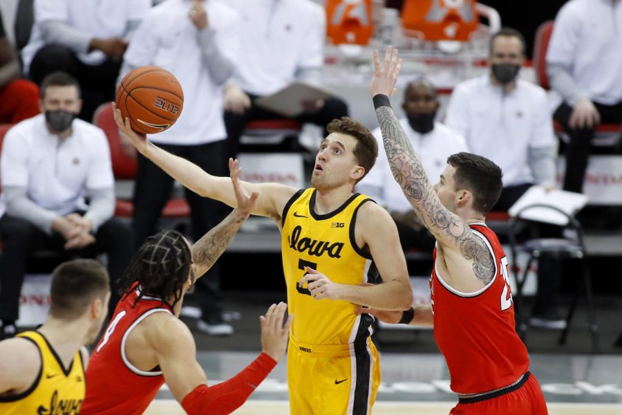 Feb 28, 2021; Columbus, Ohio, USA; Iowa Hawkeyes guard Jordan Bohannon (3) goes to the basket as Ohio State Buckeyes forward Kyle Young (25) defends during the first half at Value City Arena. Mandatory Credit: Joseph Maiorana-USA TODAY Sports