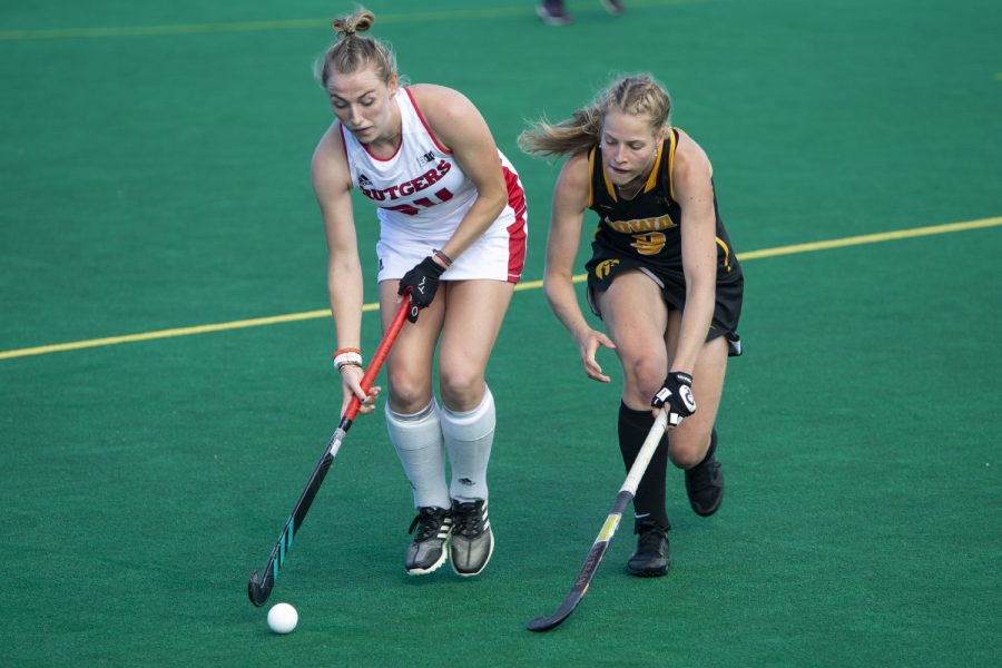 Rutgers midfielder Katie Larmour keeps the ball away from Iowa’s Sofie Stribos during the Iowa field hockey match against Rutgers on Friday, Oct. 4, 2019 at Grant Field. The Hawkeyes beat the Scarlet Knights 2-1.