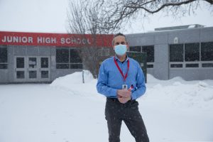 STEM teacher Bennett Brown recently resigned from teaching at Iowa City Southeast Junior High School because of state legislation requiring an in-person option learning starting February 15. Brown stands outside of Southeast Junior High School on February 13, 2021.