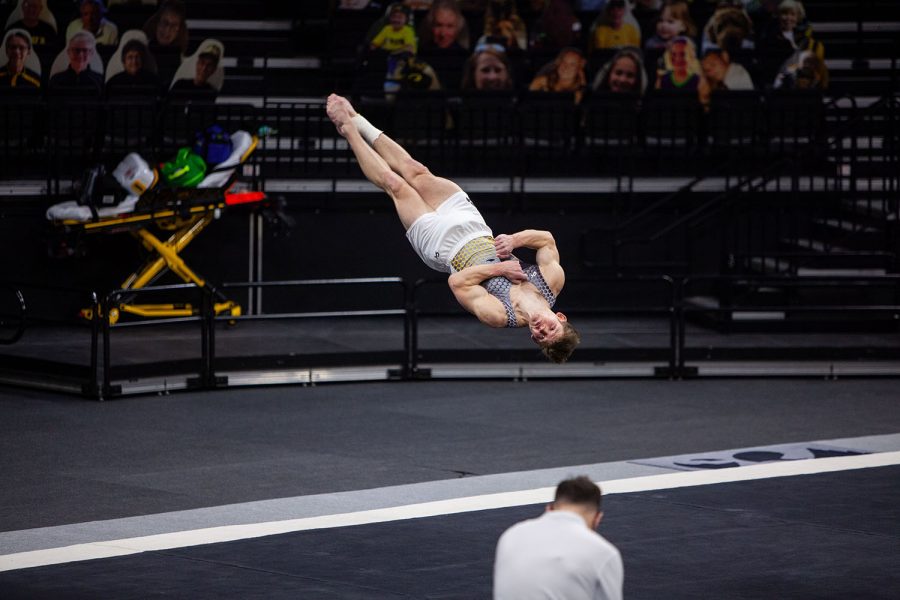 Iowa all-around Stewart Brown performs his floor routine on Saturday, Feb. 20, 2022 during the Iowa vs. Penn State men’s gymnastics meet at Carver-Hawkeye Arena. Iowa defeated Penn State 398.850-393.550. Brown placed sixth in the overall floor results with a final score of 13.500.