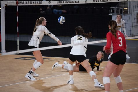 Joslyn Boyer digs the ball from the ground and passes it to teammate, Hannah Clayton, during a womens volleyball match between Iowa and Indiana at Xtream Arena on Friday, Feb. 5, 2021. 