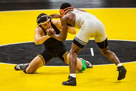 Iowa’s 174-pound Michael Kemerer grapples with Illinois’ DJ Shannon during a wrestling dual meet between Iowa and Illinois at Carver-Hawkeye Arena on Sunday, Jan. 31, 2021. No. 1 Kemerer defeated No. 26 Shannon by major decision, 10-2, and the Hawkeyes defeated the Fighting Illini, 36-6. 