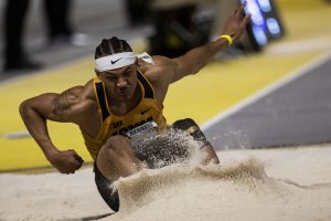 Iowas James Carter Jr. jumps into sand during the 2022 Hawkeye Invitational track and field meet at the University of Iowa Recreation Building on Saturday, Jan. 15, 2022. Iowa ran the race with a time of 3:54.00. The Hawkeye Invitational hosted Arkansas State, Bradley, Hawkeye Community College, Indian Hills Community College, Iowa Central Community College, Loyola-Chicago, Northern Iowa, South Dakota, UW-Milwaukee, and Western Illinois. 