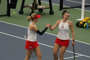 Ohio State doubles partners fist-bump at the Iowa womens tennis meet v. Ohio State on Sunday, March 7, 2021. The Hawkeyes were defeated by the Ohio State Buckeyes 2-5.