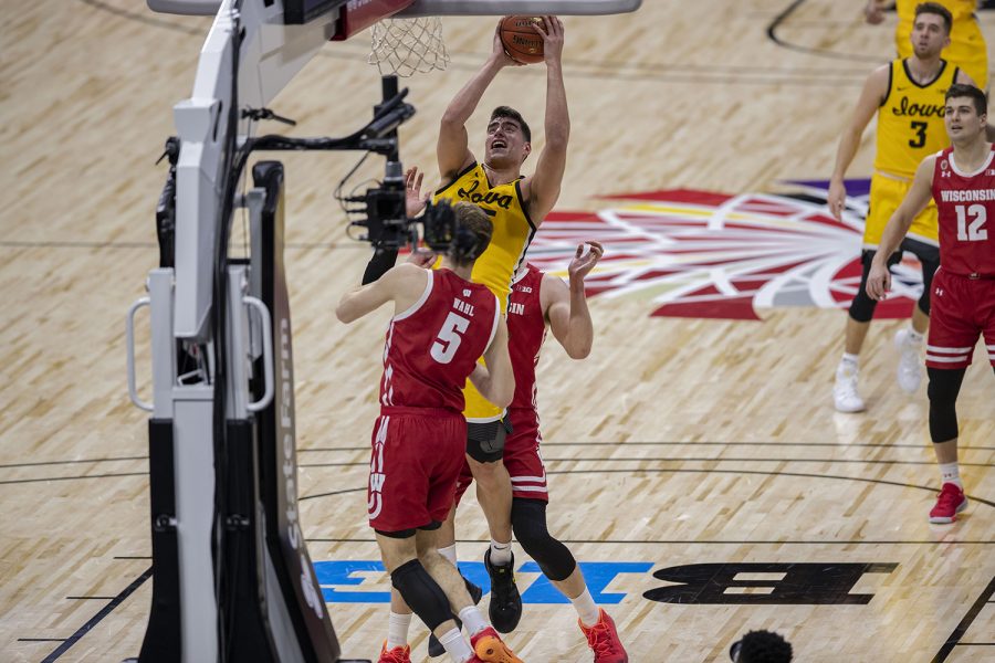 Iowa center Luka Garza attempts to shoot a basket during the first half of the Big Ten mens basketball tournament quarterfinals against Wisconsin on Friday, March 12, 2021 at Lucas Oil Stadium in Indianapolis. The Hawkeyes are behind the Badgers, 26-32 at halftime.