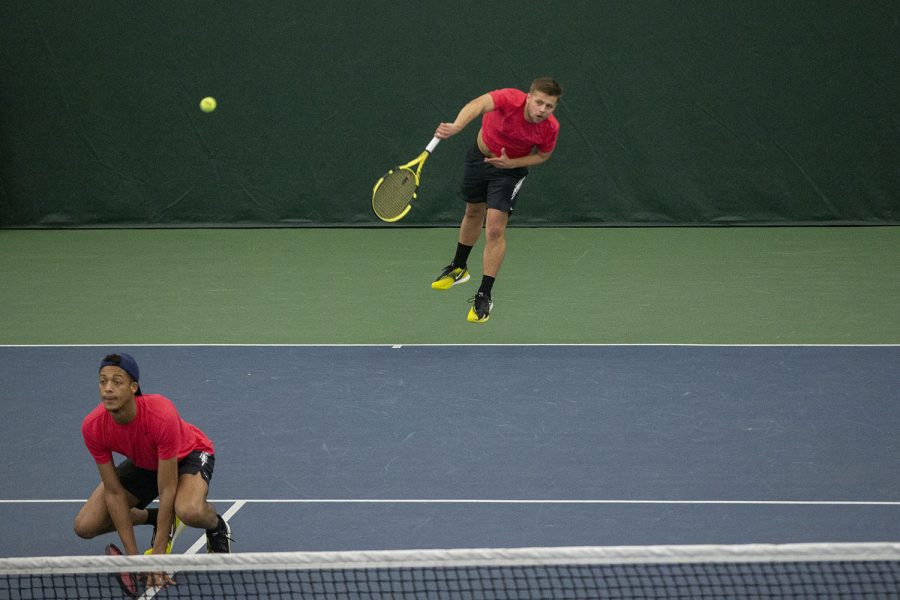 Iowa’s Will Davies serves the ball during his doubles match with partner, Oliver Okonkwo, at the Iowa Men’s tennis meet v. Wisconsin in the Hawkeye Tennis and Recreation Complex on Friday, March. 12, 2021. The Hawkeyes defeated the Badgers 5-2. 