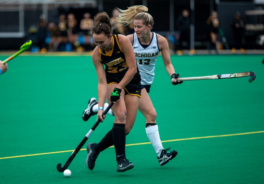 Iowa Midfielder Harper Dunne works the ball up the field during a field hockey game between Iowa and Michigan at Grant Field on Friday, March 12, 2021. The Wolverines beat the Hawkeyes 1-0. 