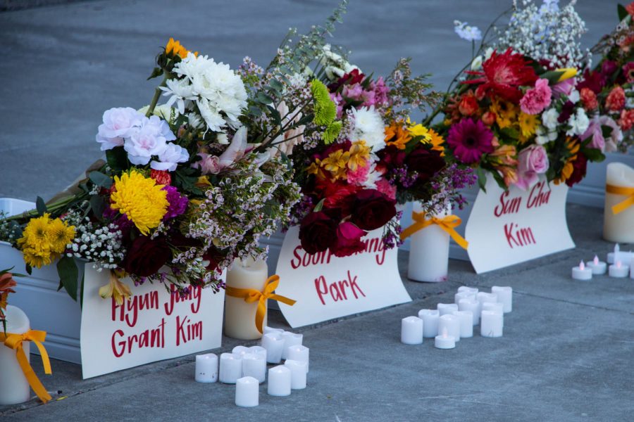 Buckets of flowers, each with their respective names, are seen during a vigil on Sunday, March 21 to honor the eight victims of the Atlanta shootings and advocate for Asian-American rights and equality. 