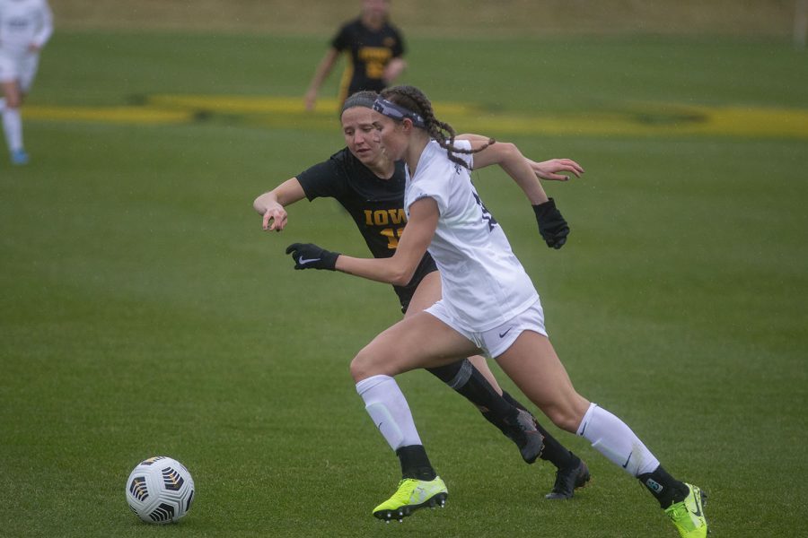 Iowa midfielder, Olivia Hellweg, and Penn State forward, Ellie Wheeler, fight for the ball during the Iowa women’s soccer match v. Penn State at the Iowa Soccer Complex on Thursday, March 25, 2021. The Nittany Lions defeated the Hawkeyes 1-0.