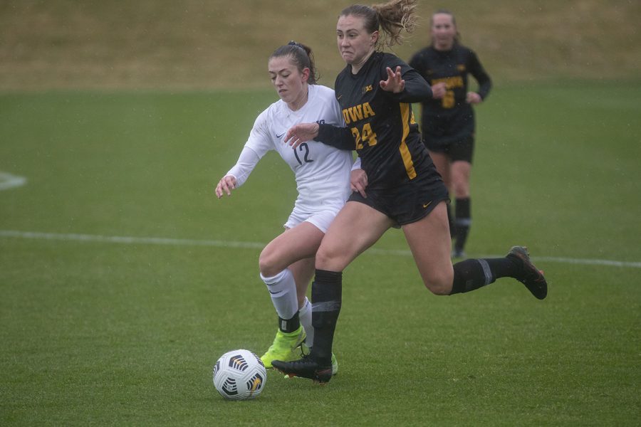 Iowa defender, Sara Wheaton, and Penn State midfielder, Payton Lineman, fight for the ball during the Iowa women’s soccer match v. Penn State at the Iowa Soccer Complex on Thursday, March 25, 2021. The Nittany Lions defeated the Hawkeyes 1-0.