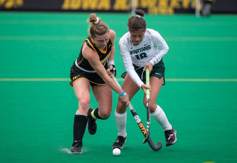 Michigan State Midfielder Merel Hanssen fights for a ball during a field hockey game between Iowa and Michigan State at Grant Field on Friday, March 26, 2021. The Hawkeyes defeated the Spartans 5-0. 