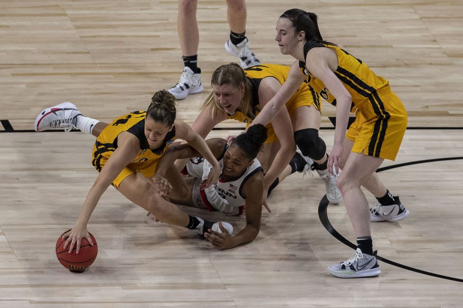 Iowa guard Gabbie Marshall fights for the ball with UConn forward Aubrey Griffin during the second quarter of the Sweet Sixteen NCAA womens basketball championship between No. 5 Iowa and No. 1 UConn on Saturday, March 27, 2021 at the Alamodome in San Antonio, Texas. The Hawkeyes are trailing behind the Huskies, 49-35 at halftime.