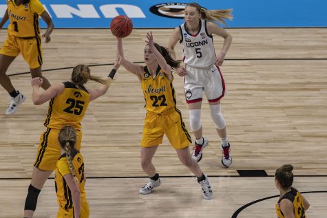 Iowa guard Caitlin Clark reaches for a pass during the first quarter of the Sweet Sixteen NCAA womens basketball championship against No. 1 UConn on Saturday, March 27, 2021 at the Alamodome in San Antonio, Texas. The Hawkeyes are trailing behind the Huskies, 49-35 at halftime.