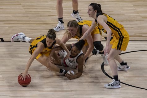 Iowa guard Gabbie Marshall fights for the ball during the second quarter of the Sweet Sixteen NCAA womens basketball championship against No. 1 UConn on Saturday, March 27, 2021 at the Alamodome in San Antonio, Texas. The Hawkeyes are trailing behind the Huskies, 49-35 at halftime. 