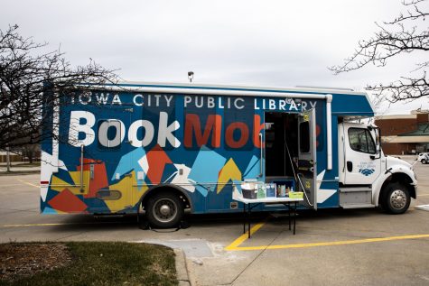 The Iowa City Public Libraries’ Bookmobile on Thursday, March 18, 2021. Sitting in the Hy-Vee parking lot, 812 S. 1st ave, one of many locations. Library patrons can place a book on hold and pick it up from the bookmobile.