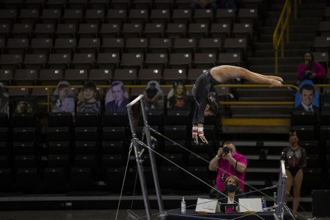 Iowas Clair Kaji performs a bars routine during a gymnastics meet against Ohio State on Saturday, Jan. 23, 2021 at Carver Hawkeye arena. The Hawkeyes defeated the Buckeyes with a score, 196.550-193.800. Kaji earned a score of 9.850. 