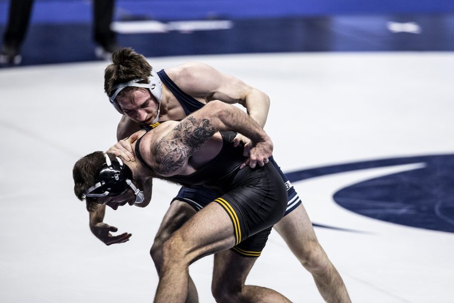 Iowa’s Michael Kemerer attempts to escape against Penn State’s Carter Starocci during the finals of the Big Ten Wrestling Tournament at the Bryce Jordan Center in State College, PA on Sunday, March 8, 2021. Kemerer won the match by decision 7-2. This is Kemerer’s first Big Ten Title. Ryan Adams/The Daily Iowan)