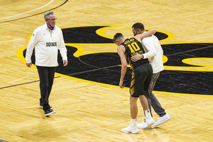 Iowa guard Joe Wieskamp limps off the court during a menÕs basketball game between Iowa and Wisconsin at Carver-Hawkeye Arena on Sunday, March 7, 2021.