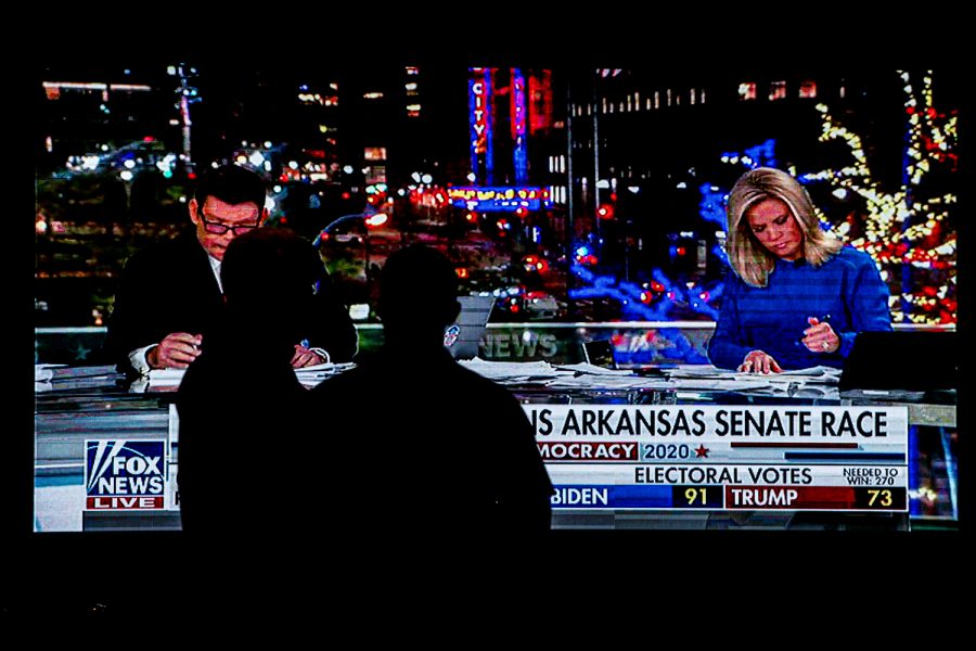 A pair of local republicans stand against a tv monitor playing the Fox News Election Coverage at the Joni Ernst Republican watch party at the Des Moins Marriott Downtown on Tuesday, November 3rd, 2020 . Republicans from across the state have gathered to watch the results of the 2020 General Election.