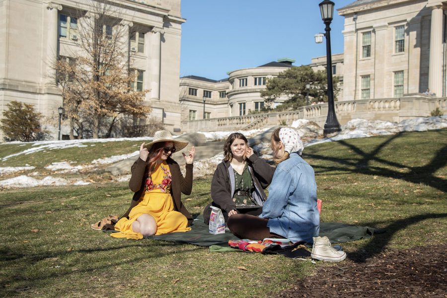 Liv Plowman (left), Makenzie Schmidt (middle), and Sophie Selc (right) are pictured having a picnic on the Pentacrest on Tuesday, March 3, 2021, University of Iowa’s instructional day. After canceling spring break, Iowa gave students and faculty two instructional breaks during the semester. 