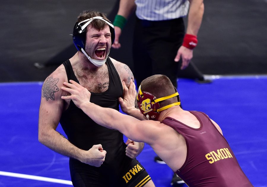 Mar 19, 2021; St. Louis, Missouri, USA;  Iowa Hawkeyes wrestler Jaydin Eierman celebrates after defeating Central Michigan Chippewas wrestler Dresden Simon in the 141 weight class during the quarterfinals of the NCAA Division I Wrestling Championships at Enterprise Center. Mandatory Credit: Jeff Curry-USA TODAY Sports