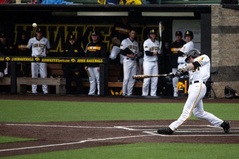 Iowa catcher Austin Martin hits the ball during the baseball game against the Spartans at Duane Banks Field on Sunday, May 12, 2019. The Hawkeyes were defeated by the Spartans 5-7.